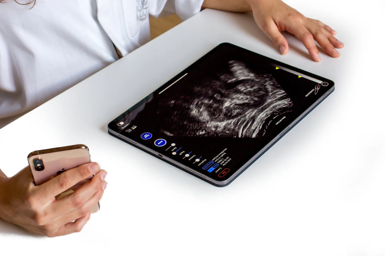 Tablet: a high-end ultrasound machine. Smartphone: the virtual ultrasound probe that controls it.